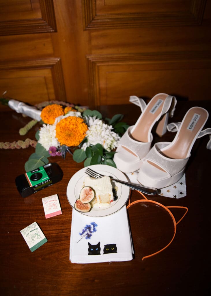late night flat lay with shoes, matchboxes, cake, napkins and bouquet