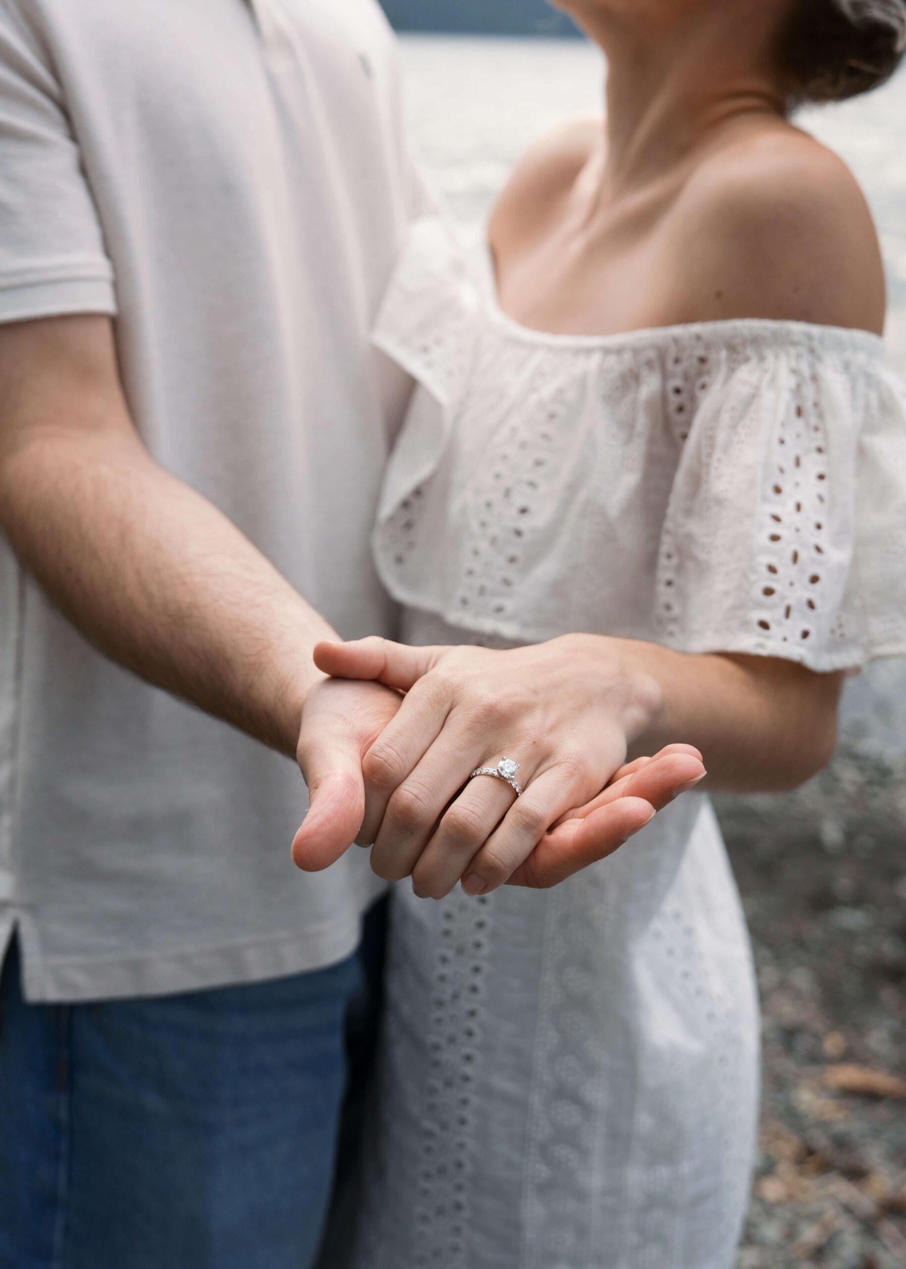 couple holding hands and showing off engagement ring at Tacoma photo location