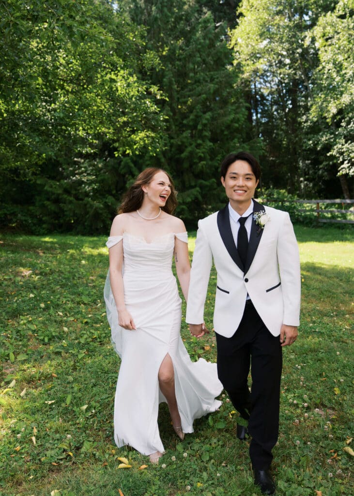 bride and groom holding hands walking outside at The Lodge at Trinity Tree Farm