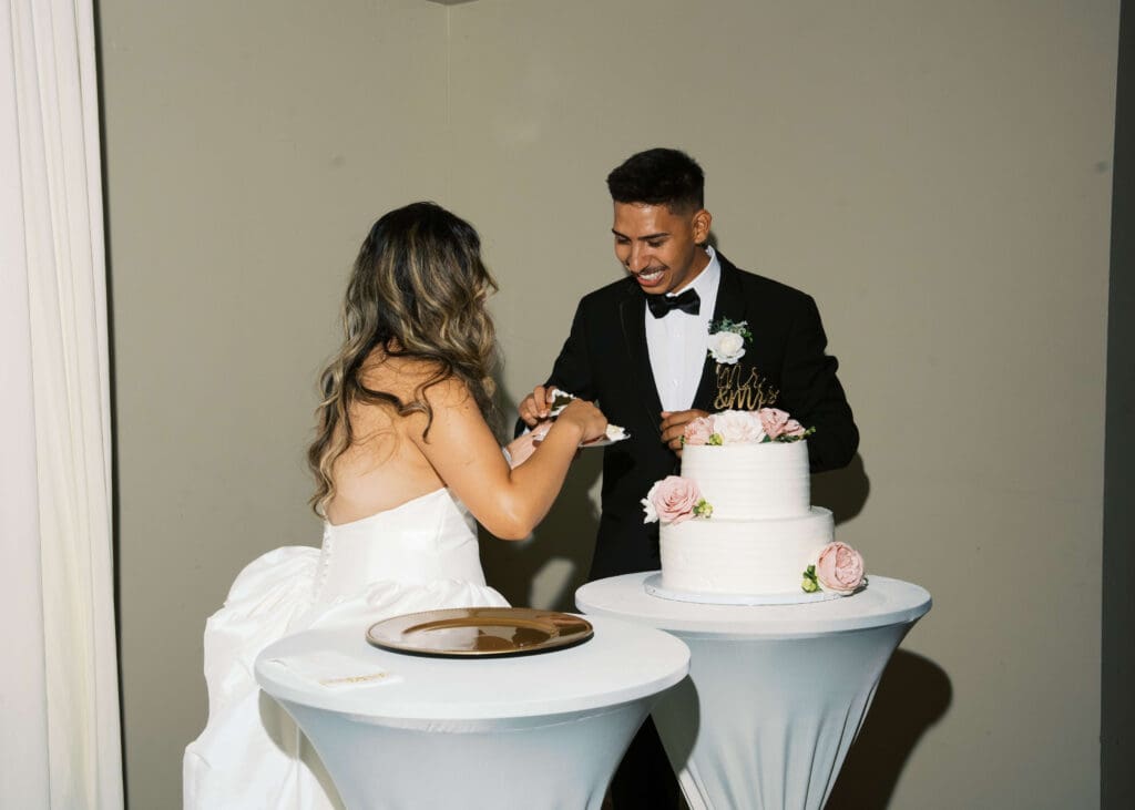 bride and groom cutting the cake at their wedding reception in downtown Tacoma 