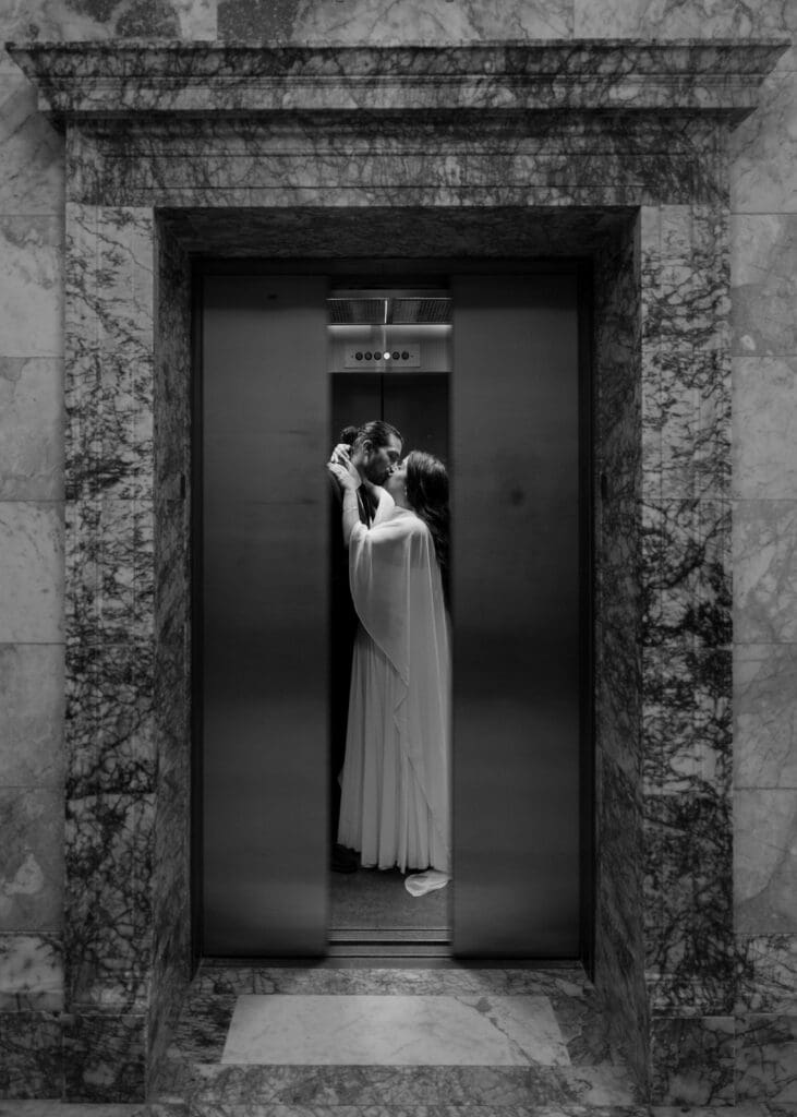 couple kissing in the elevator while the doors close at Washington State Capitol