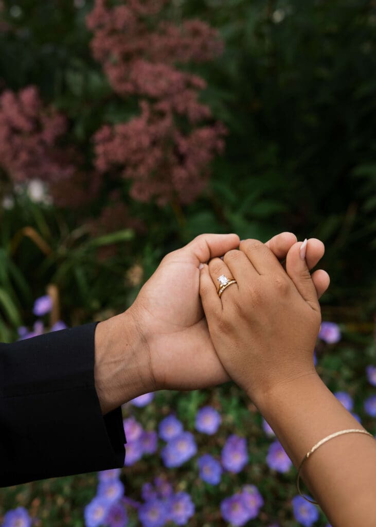 groom holding bride's hand and showing off her rings at Washington state capitol wedding