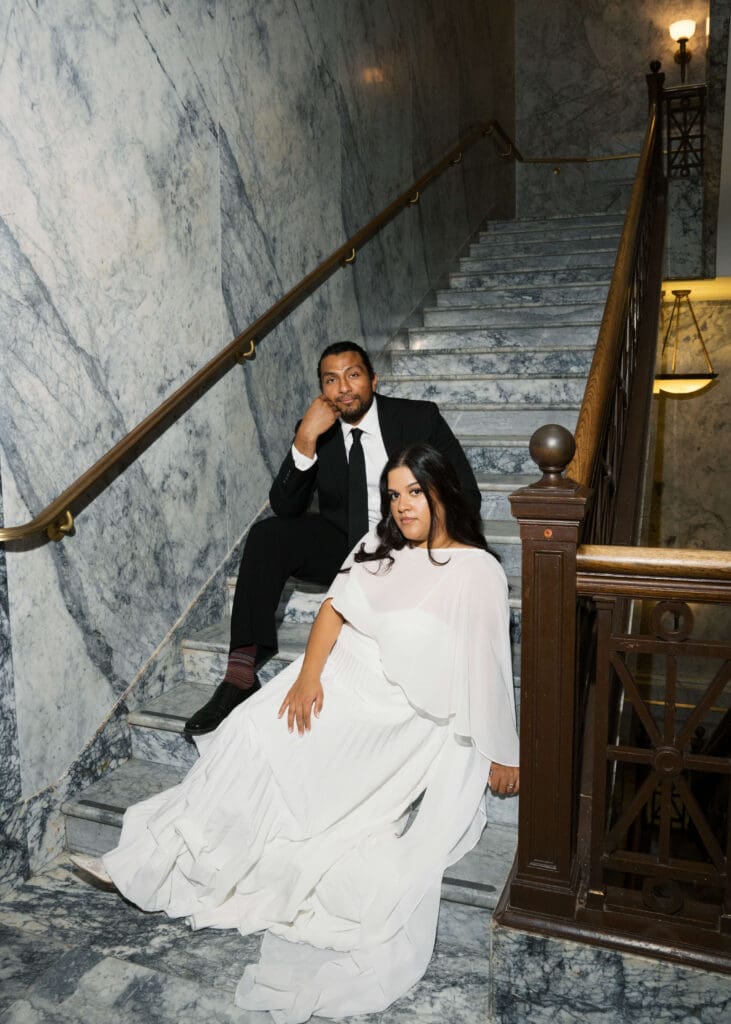 bride and groom sitting on the stairs at Washington state capitol wedding